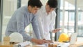 Architects and engineers inspect plans and consult for design and construction planning