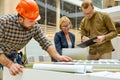 Architects and engineers working with blueprints and architectural plan Royalty Free Stock Photo