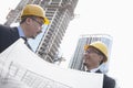 Architects looking at blueprint on construction site, Beijing Royalty Free Stock Photo