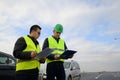 Architects looking at plans, having a discussion at construction site Royalty Free Stock Photo