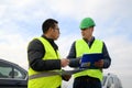 Architects looking at plans, having a discussion at construction site Royalty Free Stock Photo