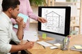 Architects making project of house on computer