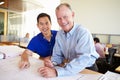 Architects Studying Plans In Modern Office Together Royalty Free Stock Photo