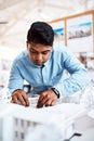 Architects think with their hands. a young architect designing a building model in a modern office. Royalty Free Stock Photo