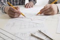 Architects working on blueprint, real estate project. Architect workplace. Construction concept. Engineering tools. Royalty Free Stock Photo