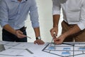 Architects working with construction drawings at table in office, closeup Royalty Free Stock Photo