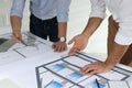 Architects working with construction drawings at table in office Royalty Free Stock Photo