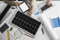 Architects working on house project with solar panels at white table. Alternative energy source Royalty Free Stock Photo