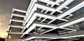 Architectural abstraction. The facade of a low-rise modern office building at night. Lots of glass and illuminated rectangular Royalty Free Stock Photo