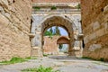 Architectural arch made of red bricks wall with blue sky background in iznik.