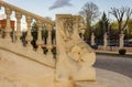 Architectural background of a balustrade topped by the effigy of a lion.