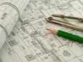 Architectural background with plan, blueprint roll, pencil and drawing compass. Technical drawings Royalty Free Stock Photo