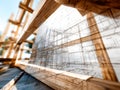 Architectural blueprint of a building under construction with wooden framework Royalty Free Stock Photo