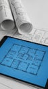 Architectural Blueprint Design on Tablet and Rolled Blueprints, Construction, CAD Royalty Free Stock Photo