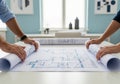 Architectural blueprint plans on a table with architects collaborating in modern workspace. concept of construction, design Royalty Free Stock Photo