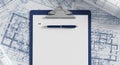 Architectural Blueprints Background with Blank Clipboard, Pen, and Copy Space for Engineering Construction Planning Royalty Free Stock Photo