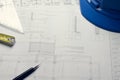 Architectural blueprints and blueprint rolls and a drawing instruments on the worktable Royalty Free Stock Photo