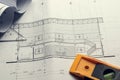 Architectural blueprints and blueprint rolls and a drawing instruments on the worktable Royalty Free Stock Photo