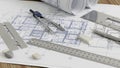 Architectural blueprints with drafting tools on a wooden table Royalty Free Stock Photo