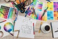Architectural blueprints with paper and wooden color sampler on creative desk Royalty Free Stock Photo