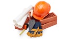 Architectural blueprints, stack of bricks, masonry trowel,  construction hard hat on white background. Construction concept Royalty Free Stock Photo