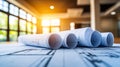 Architectural blueprints unrolled on a table in a bright, sunlit room, a concept for construction Royalty Free Stock Photo