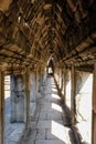 An architectural close-up of an ancient corridor with a stone vaulted ceiling