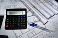 Architectural design, drawings, rolls of drawings on the table. calculator and two ballpoint pens Royalty Free Stock Photo