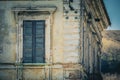 Architectural detail of an ancient house with window with green shutter. Royalty Free Stock Photo