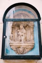 Architectural detail - a bas-relief sculpture of the Virgin Mary with the baby Jesus. Venice, Italy. The bas-relief is Royalty Free Stock Photo