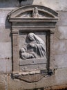 Architectural detail - a bas-relief sculpture of the Virgin Mary with the baby Jesus. Venice, Italy. The bas-relief is Royalty Free Stock Photo
