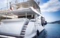 Architectural detail of a brand new superyacht, with guest cabin windows and bridge