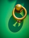 Architectural detail of brass door knocker with green door and d Royalty Free Stock Photo