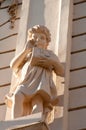 Architectural detail on a building. Carved statue of child.