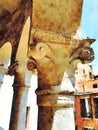 An architectural detail of a capital of a column of a historic building in the center of Venice