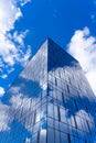 Architectural detail of the facade with multiple reflections of cloudy sky and the sun Royalty Free Stock Photo