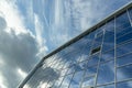 Architectural detail of the facade with multiple reflections of cloudy sky and the sun Royalty Free Stock Photo