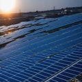 Architectural Detail of Metal Roofing on Commercial Construction Solar panels or Solar cells Over Factory, Blue Sky With Sun Rays Royalty Free Stock Photo