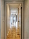 Architectural detail narrow corridor with white walls and polished concrete floor