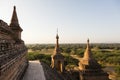 Architectural detail of a pagoda in the foreground and the pagoda field of Bagan in background Royalty Free Stock Photo