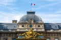 Architectural detail of Palais de Justice courthouse and gate with golden decoration in Paris, France