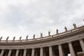 Architectural detail of saint peters basilica colonnade with statues standing on columns Royalty Free Stock Photo