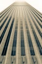 Architectural detail of skyscraper rising into misty sky above, Royalty Free Stock Photo