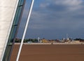 Architectural detail of southport pier with the beach at low tide and the historic amusement park in the distance against a Royalty Free Stock Photo