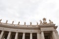 Architectural detail of st peters basilica colonnade with statues standing on columns Royalty Free Stock Photo
