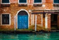 Architectural detail of vintage brick walls, doors and windows in Venice canal, Italy Royalty Free Stock Photo