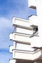 Architectural detail from a white modern concrete building with rectangular details against the blue sky Royalty Free Stock Photo