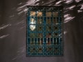 Architectural detail of a window with an oriental fence at sunset in Majorelle garden, Marrakech, Morocco Royalty Free Stock Photo