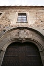 Architectural details and blazonry on the wall of The Episcopal Palace in Caceres Royalty Free Stock Photo