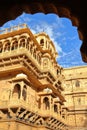 The architectural details of Jaisalmer fort palace viewed through an arcade in Jaisalmer, Rajasthan, India